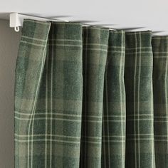 green plaid curtains hanging on the side of a wall