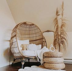 a wicker swing chair and ottoman in a living room