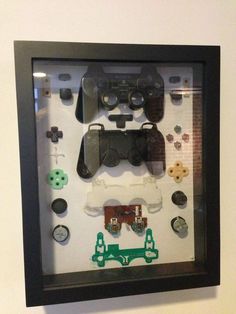 a display case with video game controllers and buttons on the wall in front of it