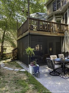 an outdoor patio with table, chairs and umbrella