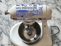 a kitchen aid mixer sitting on top of a marble counter with the words recipe written on it