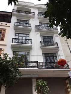 an apartment building with balconies on the second floor