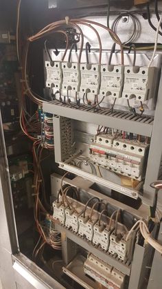 the inside of an electrical panel with many wires