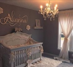 a baby's room with a chandelier and crib in the corner