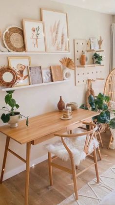 a wooden table sitting in the middle of a living room filled with plants and pictures