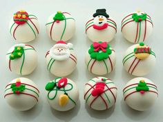 there are many white chocolates decorated with christmas decorations and candy canes on them