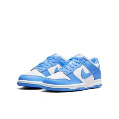 The Nike Dunk Low GS 'University Blue' is a sneaker that pays homage to its collegiate hardwood roots. This low-top shoe features a leather upper in a color-blocked design, with a crisp white base and pastel blue finish on the eyestay, Swoosh, and heel and forefoot overlays. Nike branding is featured on the tongue tag and heel tag, while the shoe sits on a durable rubber cupsole. The outsole provides performance-ready traction, making this sneaker perfect for big kids who want a stylish and functional sneaker. Unc University, Customized Shoes, Blue Jordans, Fresh Sneakers, Nike Models, Cute Nike Shoes, Fresh Shoes, Cute Nikes, Sb Dunk