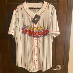 a baseball jersey hanging on a door with the name amazing spiderman written on it