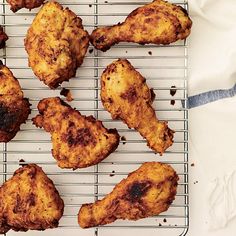 four pieces of fried chicken on a cooling rack