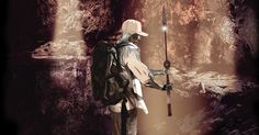 a man holding a fishing pole while standing in front of a cave filled with water