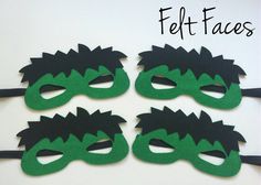 three masks with green and black hair are on a white surface next to the words felt faces