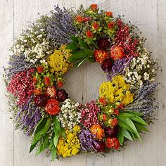 a wreath made out of flowers and greenery