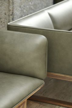 two green leather couches sitting next to each other