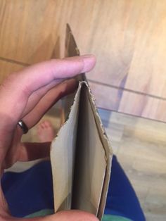 a person holding an open piece of paper in their left hand and the other half of it