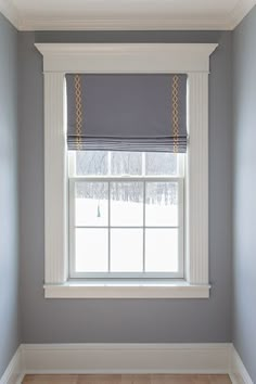 an empty room with blue walls and white trim on the window sill is shown