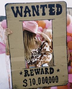 a cardboard sign that says wanted reward $ 10, 000 00 per square with an image of a woman in a cowboy hat