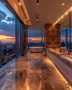 a bathroom with large windows overlooking the city at sunset or dawn, and a jacuzzi tub in the middle