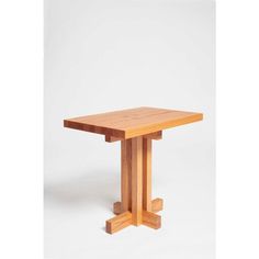 a wooden table sitting on top of a white floor