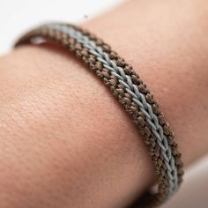 a close up of a person's arm with a bracelet on it