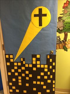 a door decorated to look like a castle with a cross on it and yellow squares