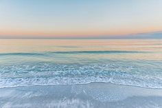 the beach is clean and empty at sunset