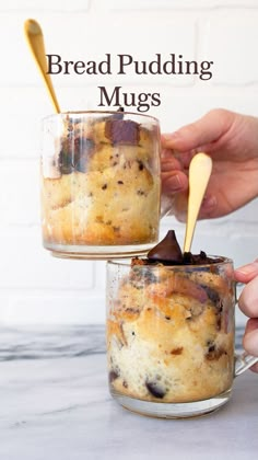 two jars filled with bread pudding sitting on top of a counter next to a hand holding a spoon