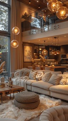 a living room filled with lots of furniture next to a large glass window covered in hanging lights