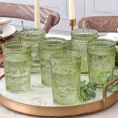 a tray with green glass glasses on top of it