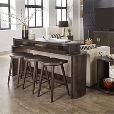 a living room filled with furniture and a flat screen tv on top of a wooden table