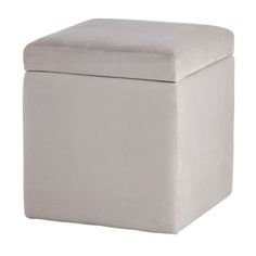 a white ottoman with a cushion on it