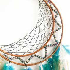 a close up of a dream catcher with beads