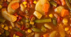 a bowl filled with stew and vegetables on top of a table