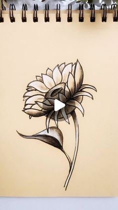 a drawing of a sunflower on a notepad