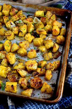 roasted potatoes on a baking sheet with herbs