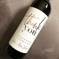 a bottle of wine with the words thank you written on it