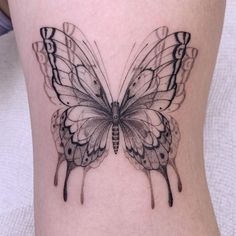 a black and white butterfly tattoo on the leg by las vegas, nevvesa