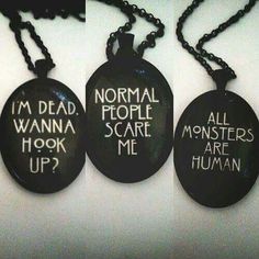 three black key chains with white writing on them that say i'm dead people scare me