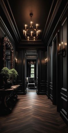 an elegant hallway with black walls and wood floors