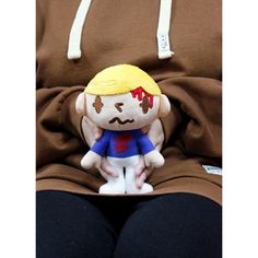 a stuffed toy is sitting on someone's lap