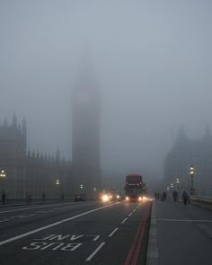 the big ben clock tower towering over the city of london on a foggy day