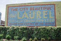 a large sign on the side of a building that says, the city beautiful laurel