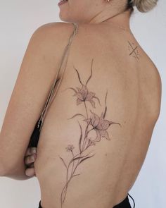 the back of a woman's body with flowers on it