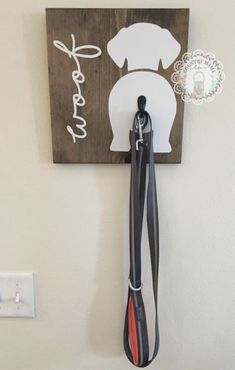 a dog leash holder is mounted on the wall