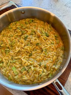 a large pot filled with food on top of a wooden table