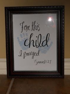 a framed sign with the words for this child and handprinted footprints on it