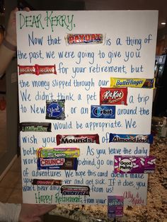 a sign with candy written on it in front of a counter