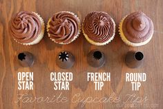 cupcakes with chocolate frosting are lined up on a wooden table and labeled in different ways