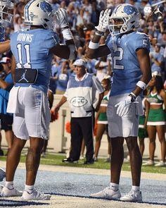 two football players giving each other high fives