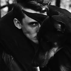 a man and his dog pose for a black and white photo