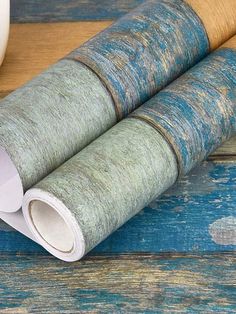 two rolled up papers sitting on top of a wooden table